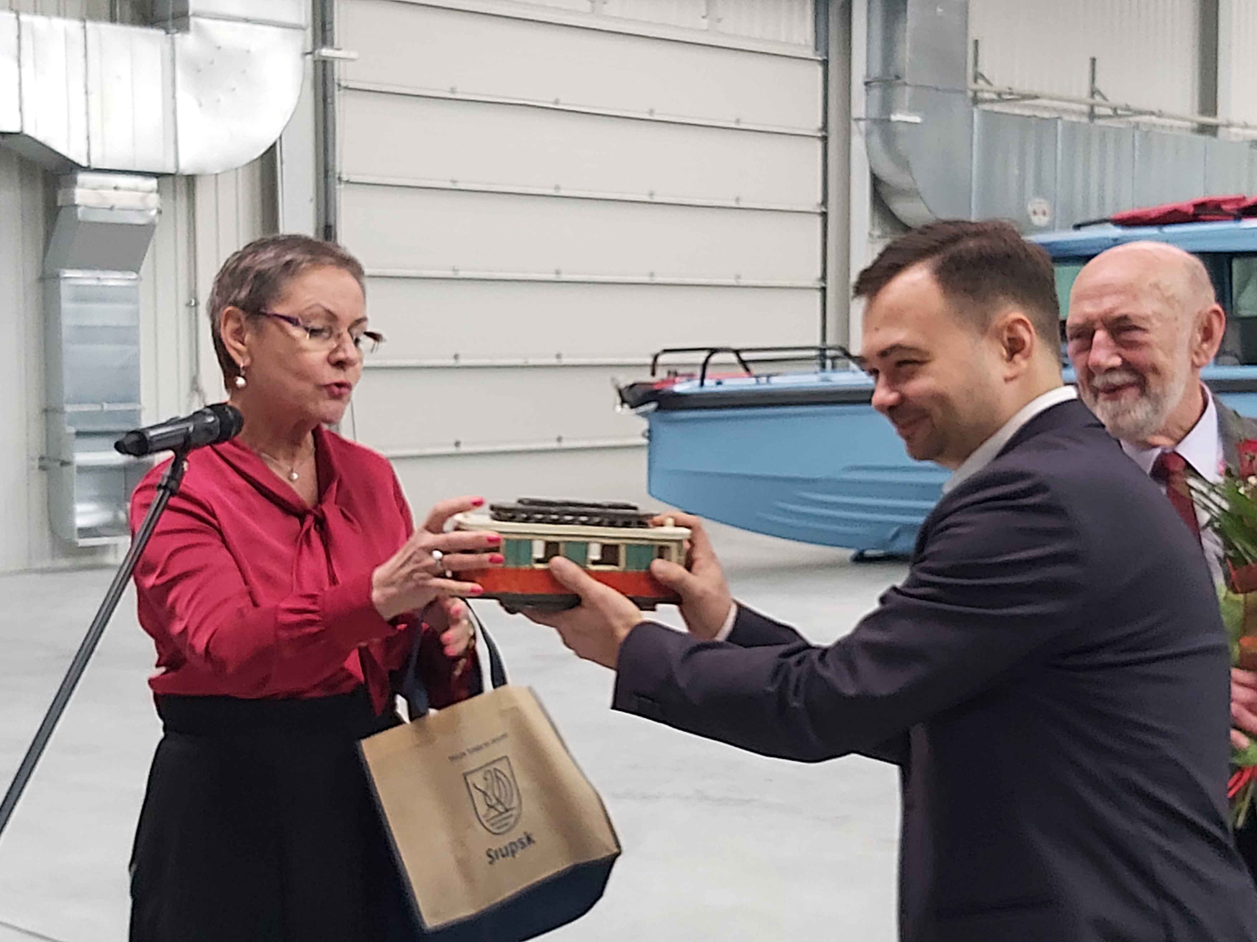 Prezydentka MIasta wręcza ceramiczny tramwaj Szymonowi Koseskiemu Członkowi Zarządu Firmy Markos