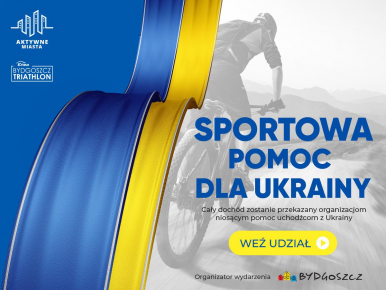 Flaga Ukrainy, w tle mężczyzna jedzie na rowerze.