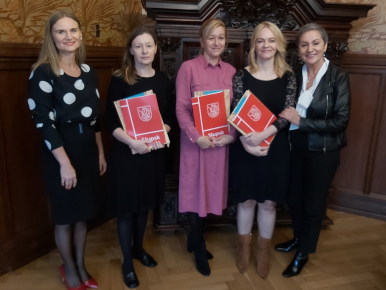 Na zdjęciu widzimy 5 kobiet - Finalistki  konkursu oraz Prezydentka i Wiceprezydentka Słupska; Finalistki trzymają teczki prezydenckie z listami gratulacyjnymi