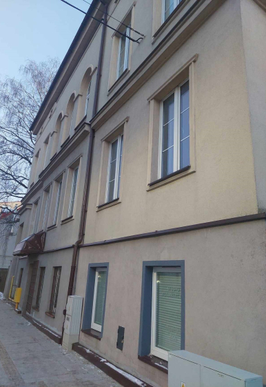 Zdjęcie przedstawia budynek, w którym znajdują się lokal mieszkalny na sprzedaż.