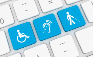 Zdjęcie przedstawia klawiaturę komputerową z niebieskimi przyciskami przedstawiającymi niepełnosprawności (FOT. PIXABY)
