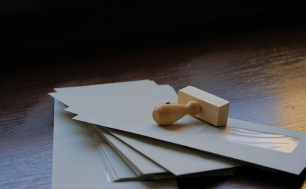 Grafika przedstawia stos kopert i pieczątkę. (Fot.pixabay)