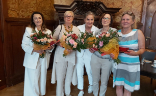 4 Panie przechodzące na emeryturę oraz Prezydentka Słupska; urzędniczki trzymają bukiety kwiatów